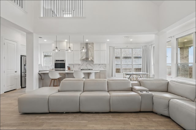 1001 Gentle Knoll Ln, Prosper, TX 75078 - living room featuring a high ceiling, light wood finished floors, and recessed lighting