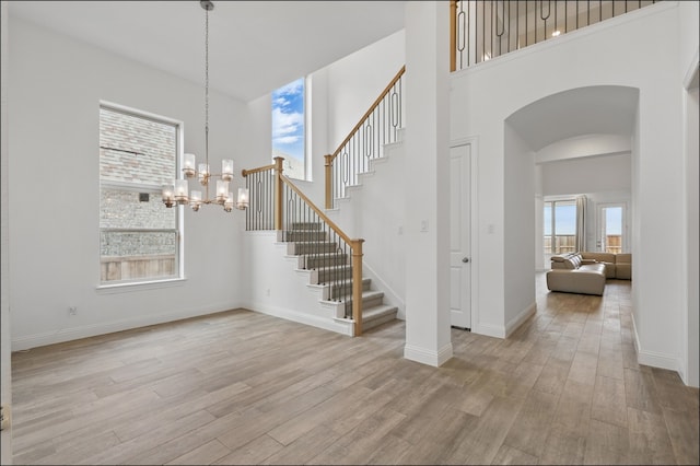 1001 Gentle Knoll Ln, Prosper, TX 75078 - entryway featuring healthy amount of natural light, light wood finished floors, arched walkways, and a high ceiling