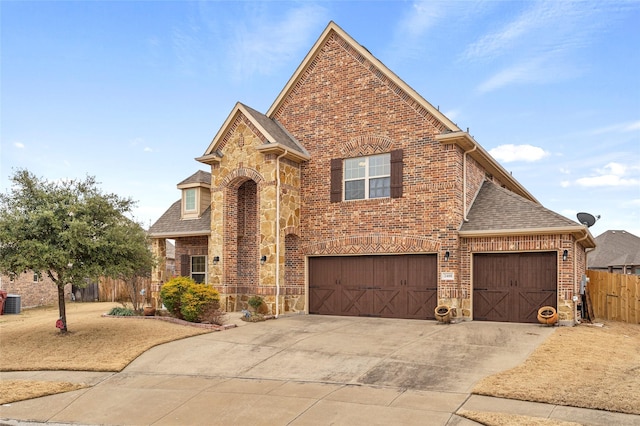 2408 Comal Ct, Royse City, TX 75189 - traditional-style home with brick siding, roof with shingles, stone siding, and driveway