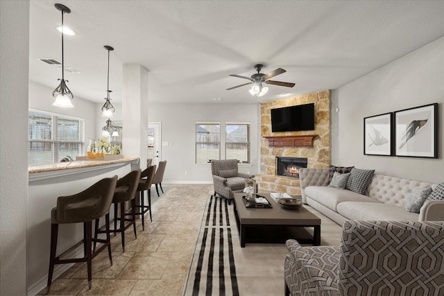 2408 Comal Ct, Royse City, TX 75189 - living room with a fireplace, healthy amount of natural light, a ceiling fan, and baseboards