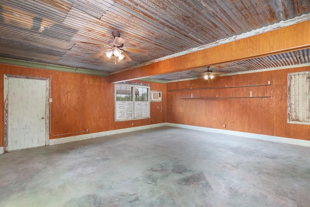 2992 County Road 100, Brady, TX 76825 - empty room with concrete floors, ceiling fan, wood walls, and an AC wall unit