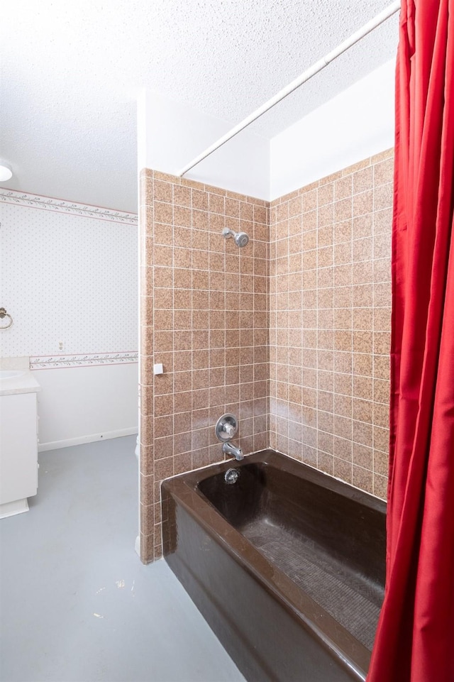 2992 County Road 100, Brady, TX 76825 - full bathroom with shower / tub combination, concrete flooring, vanity, a textured ceiling, and wallpapered walls