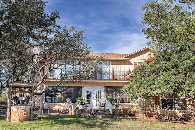 2992 County Road 100, Brady, TX 76825 - rear view of house featuring a balcony, french doors, a patio area, and a lawn