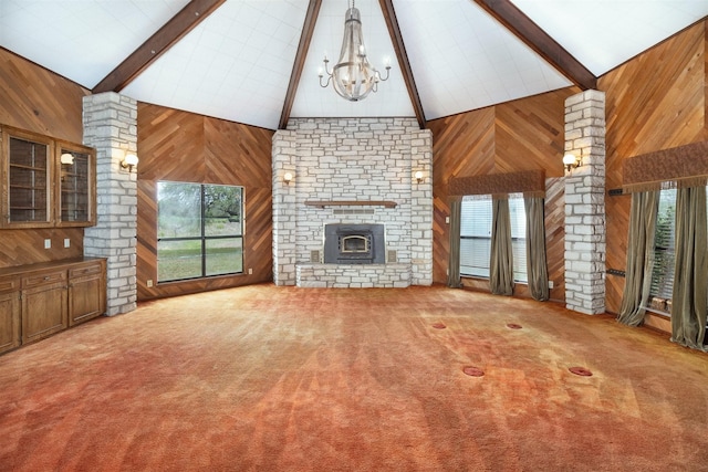 2992 County Road 100, Brady, TX 76825 - unfurnished living room with wooden walls, a chandelier, carpet floors, and a brick fireplace