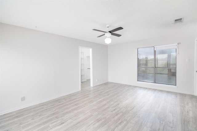2992 County Road 100, Brady, TX 76825 - spare room featuring light wood finished floors, a ceiling fan, and baseboards