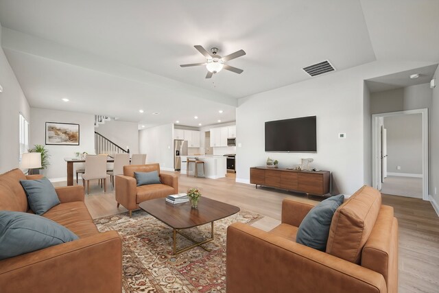 516 Stagg St, Mckinney, TX 75069 - living room with light wood-style floors, ceiling fan, stairs, baseboards, and recessed lighting