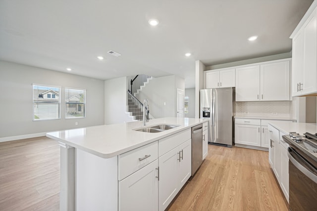 516 Stagg St, Mckinney, TX 75069 - kitchen with a sink, appliances with stainless steel finishes, light wood-style flooring, light countertops, and recessed lighting
