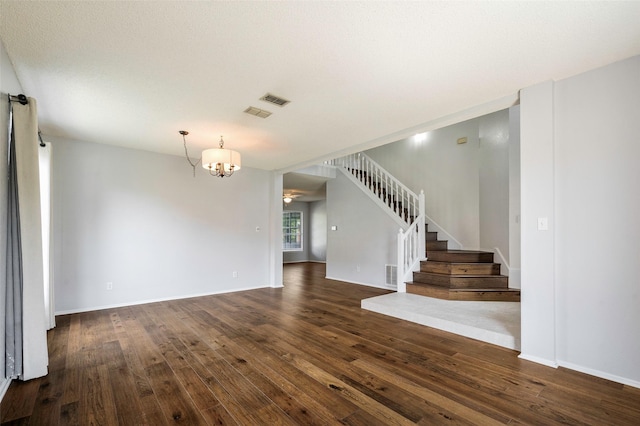 2221 Bennington Ave, Flower Mound, TX 75028 - unfurnished living room with dark wood-style floors, stairs, a chandelier, and baseboards