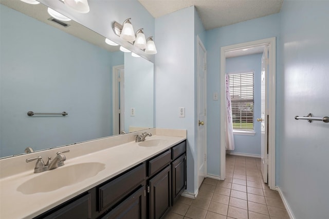 2221 Bennington Ave, Flower Mound, TX 75028 - full bathroom featuring double vanity, tile patterned floors, and baseboards