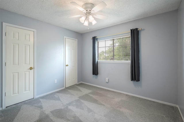2221 Bennington Ave, Flower Mound, TX 75028 - unfurnished bedroom featuring carpet floors, a textured ceiling, baseboards, and a ceiling fan