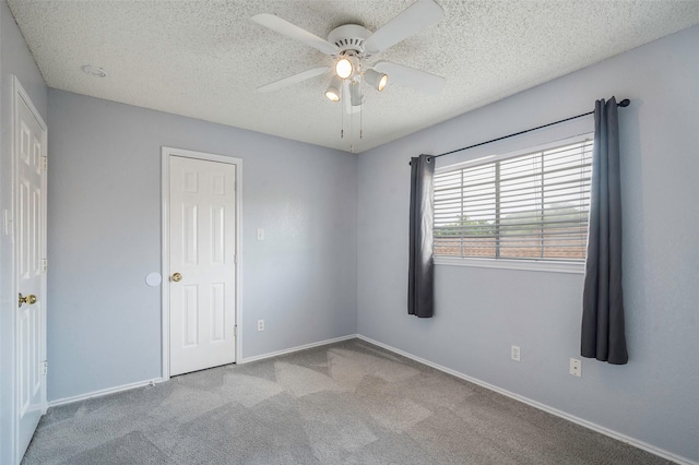 2221 Bennington Ave, Flower Mound, TX 75028 - unfurnished bedroom with a textured ceiling, carpet flooring, baseboards, and a ceiling fan