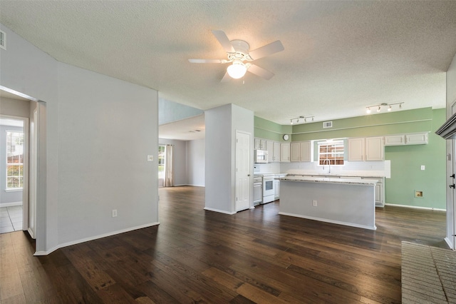2221 Bennington Ave, Flower Mound, TX 75028 - kitchen with white appliances, a ceiling fan, a kitchen island, dark wood-style floors, and healthy amount of natural light