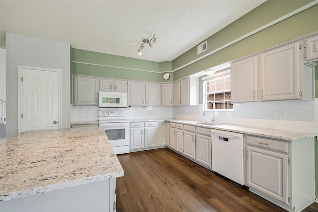 2221 Bennington Ave, Flower Mound, TX 75028 - kitchen with white appliances, a sink, decorative backsplash, dark wood-style floors, and a textured ceiling