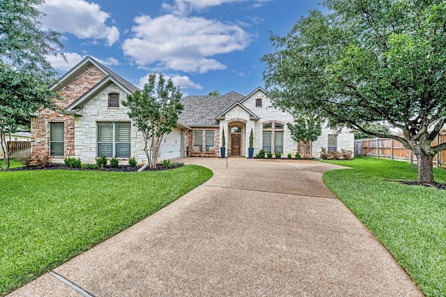 103 Saintsbury Cir, Waco, TX 76712 - view of front facade featuring stone siding, concrete driveway, a garage, and brick siding