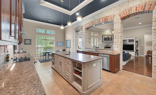 103 Saintsbury Cir, Waco, TX 76712 - kitchen featuring stainless steel dishwasher, decorative columns, a sink, a spacious island, and crown molding