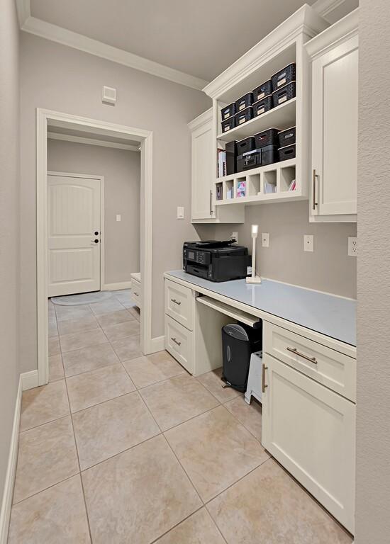 103 Saintsbury Cir, Waco, TX 76712 - kitchen featuring crown molding, open shelves, white cabinetry, light countertops, and light tile patterned flooring