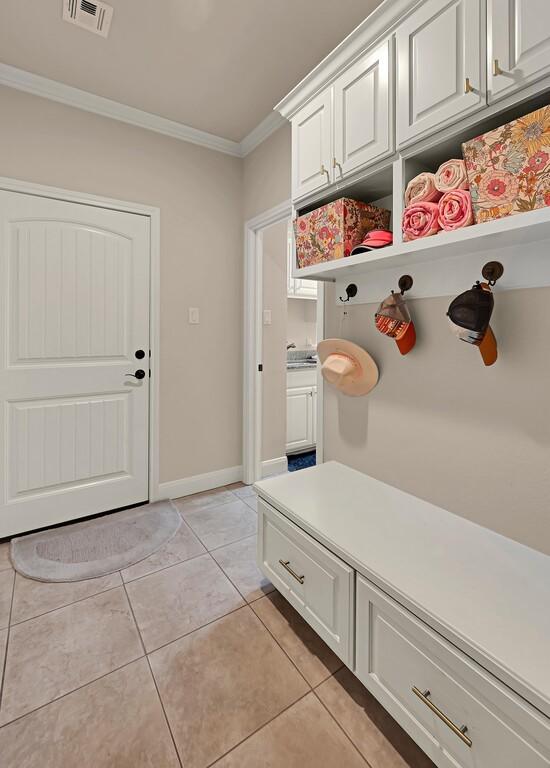 103 Saintsbury Cir, Waco, TX 76712 - mudroom with ornamental molding, light tile patterned floors, and baseboards