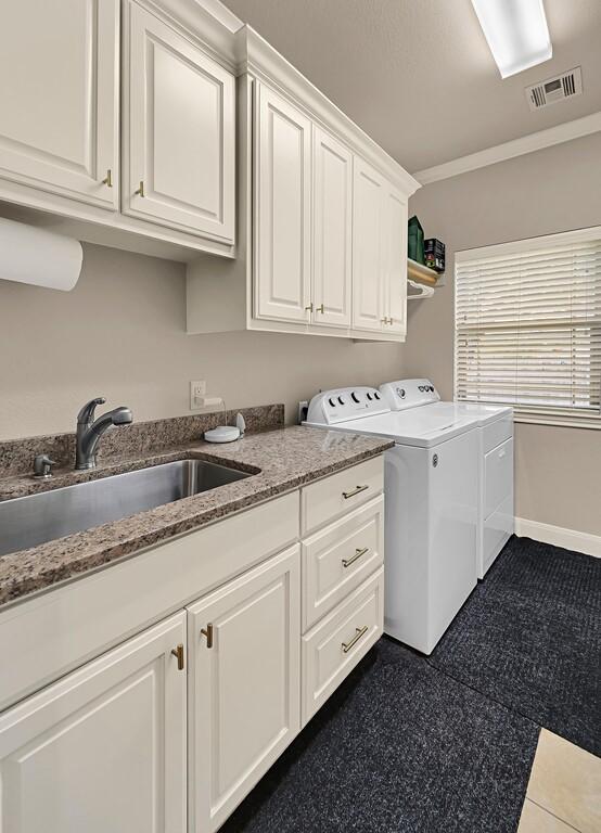 103 Saintsbury Cir, Waco, TX 76712 - washroom with cabinet space, independent washer and dryer, crown molding, and baseboards