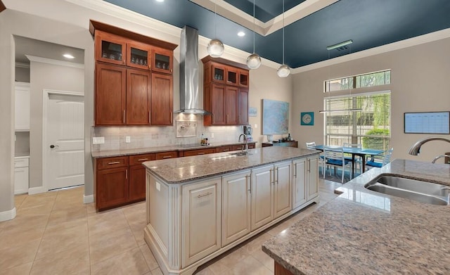 103 Saintsbury Cir, Waco, TX 76712 - kitchen with a sink, wall chimney exhaust hood, ornamental molding, a center island with sink, and tasteful backsplash