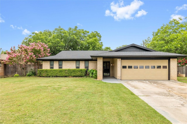 2507 16th St, Brownwood, TX 76801 - ranch-style home with brick siding, an attached garage, driveway, and roof with shingles