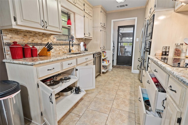 2507 16th St, Brownwood, TX 76801 - kitchen featuring a sink, black electric cooktop, backsplash, light tile patterned floors, and stainless steel dishwasher