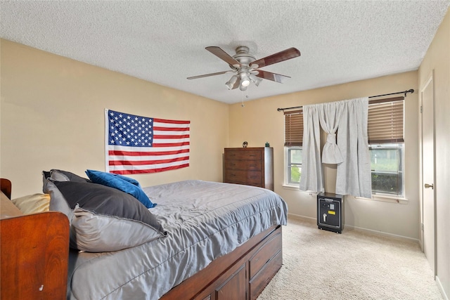 2507 16th St, Brownwood, TX 76801 - bedroom featuring light carpet, baseboards, a textured ceiling, and a ceiling fan
