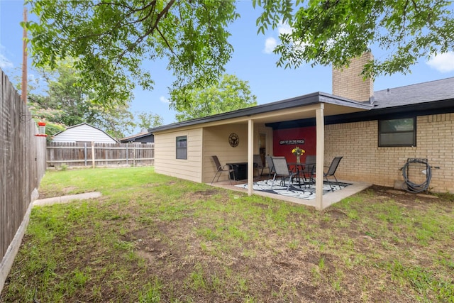 2507 16th St, Brownwood, TX 76801 - back of house featuring a chimney, a patio, and brick siding