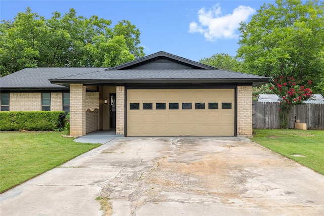 2507 16th St, Brownwood, TX 76801 - ranch-style home with brick siding, driveway, a garage, and a shingled roof