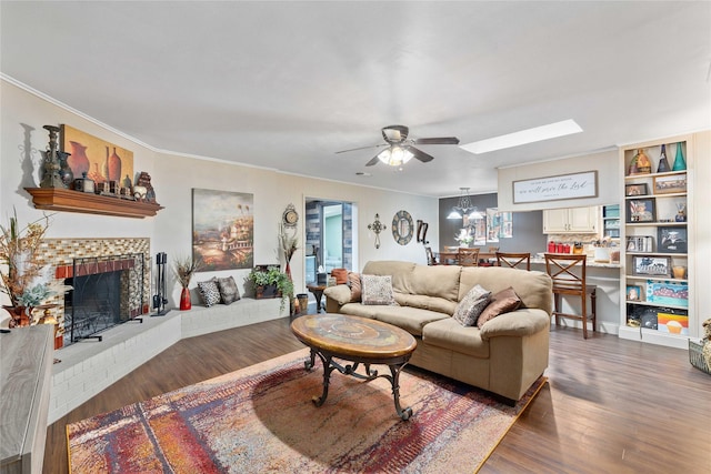 2507 16th St, Brownwood, TX 76801 - living area featuring a ceiling fan, ornamental molding, a fireplace, wood finished floors, and a skylight