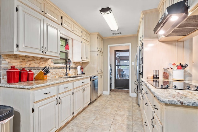 2507 16th St, Brownwood, TX 76801 - kitchen with range hood, a sink, stainless steel appliances, tasteful backsplash, and plenty of natural light