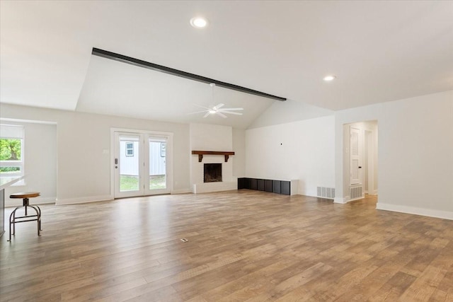 3201 Carroll Dr, Waco, TX 76708 - unfurnished living room featuring vaulted ceiling, a fireplace, ceiling fan, baseboards, and light wood-style floors