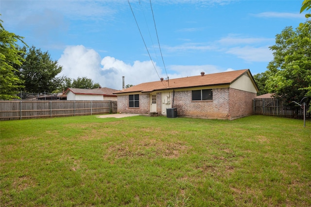 6003 Springwood Dr, Arlington, TX 76001 - back of house featuring brick siding, central AC, and a patio