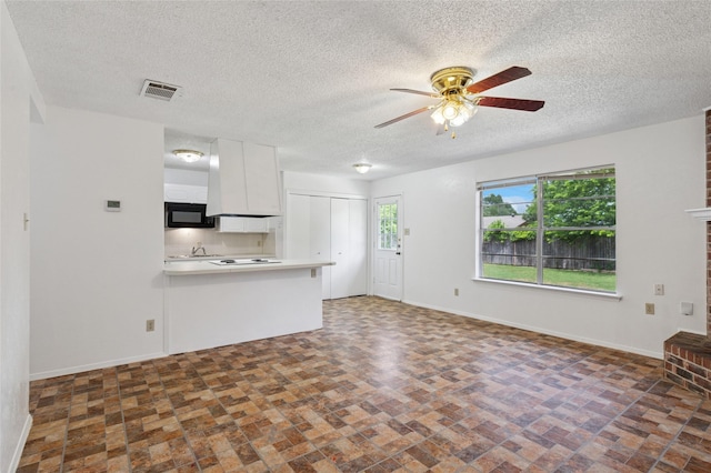 6003 Springwood Dr, Arlington, TX 76001 - unfurnished living room with a ceiling fan, baseboards, and a textured ceiling