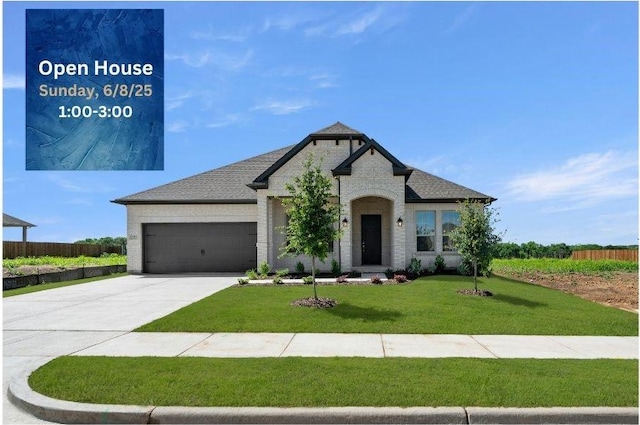 2397 Rams Horn Dr, Waxahachie, TX 75165 - view of front of home featuring an attached garage, concrete driveway, and brick siding