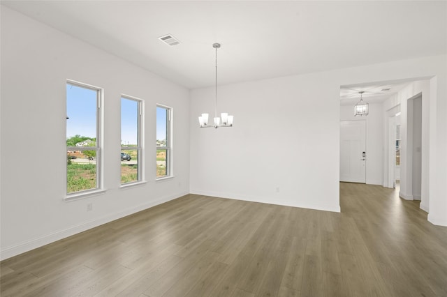 2397 Rams Horn Dr, Waxahachie, TX 75165 - spare room featuring a chandelier, wood finished floors, and baseboards