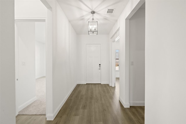 2397 Rams Horn Dr, Waxahachie, TX 75165 - hall with a chandelier, wood finished floors, and baseboards
