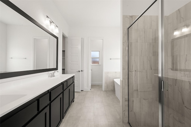 2397 Rams Horn Dr, Waxahachie, TX 75165 - full bath with a freestanding tub, double vanity, a shower stall, and tile patterned flooring