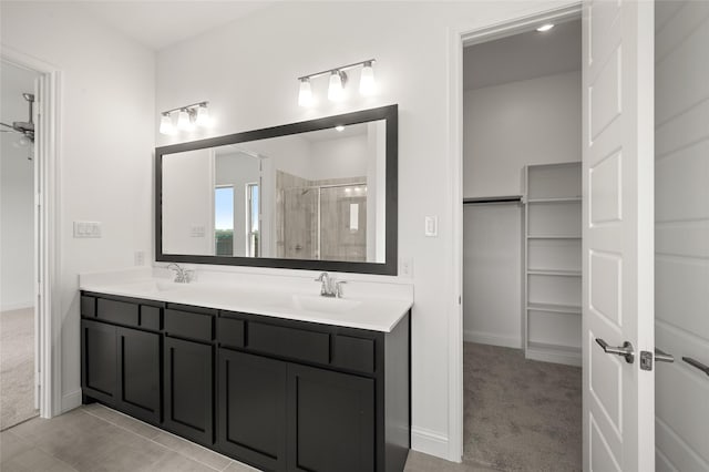 2397 Rams Horn Dr, Waxahachie, TX 75165 - bathroom featuring a shower stall, double vanity, a spacious closet, and baseboards