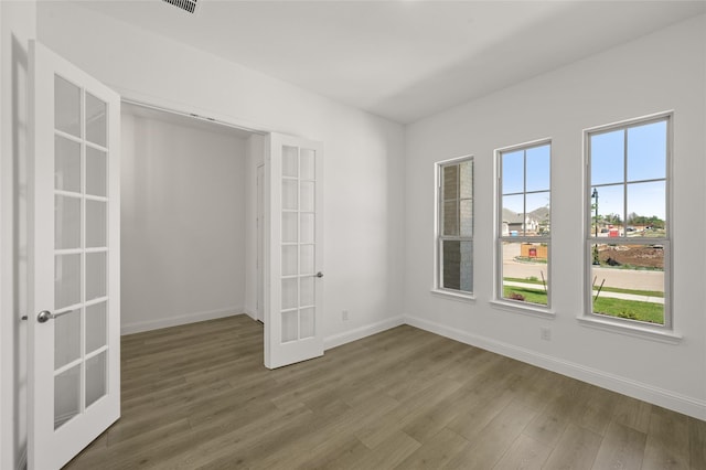 2397 Rams Horn Dr, Waxahachie, TX 75165 - spare room with french doors, wood finished floors, and baseboards