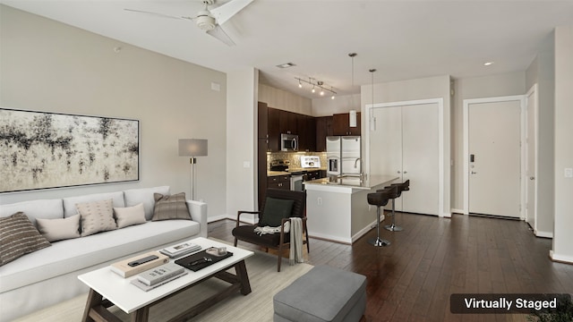 2950 Mckinney Ave Unit 316, Dallas, TX 75204 - living room with a ceiling fan, dark wood-type flooring, track lighting, and baseboards