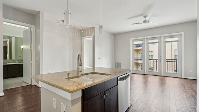 2950 Mckinney Ave Unit 316, Dallas, TX 75204 - kitchen with a sink, stainless steel dishwasher, dark wood finished floors, a ceiling fan, and an island with sink