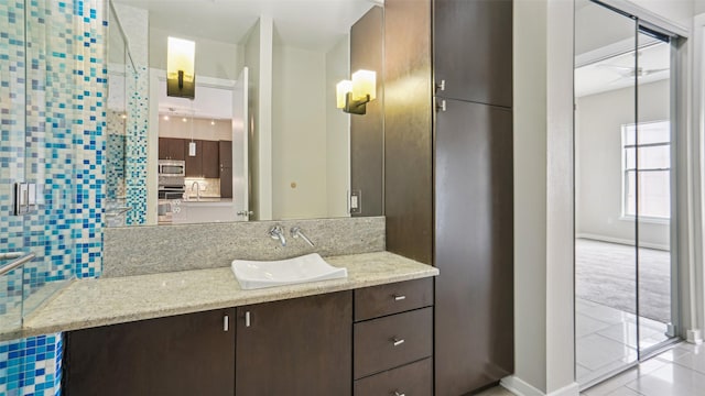 2950 Mckinney Ave Unit 316, Dallas, TX 75204 - bathroom featuring vanity, tasteful backsplash, baseboards, tile patterned floors, and a stall shower