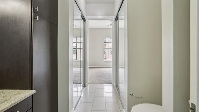 2950 Mckinney Ave Unit 316, Dallas, TX 75204 - hall featuring light tile patterned floors and baseboards