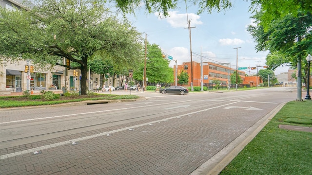2950 Mckinney Ave Unit 316, Dallas, TX 75204 - view of decorative street with curbs, street lighting, sidewalks, traffic lights, and traffic signs