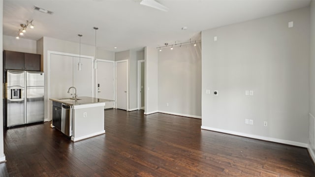 2950 Mckinney Ave Unit 316, Dallas, TX 75204 - kitchen with stainless steel fridge with ice dispenser, a sink, dark wood finished floors, a kitchen island with sink, and track lighting