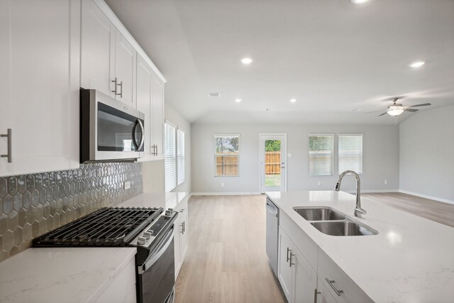 414 Stagg St, Mckinney, TX 75069 - kitchen featuring stainless steel appliances, a sink, open floor plan, light wood-style flooring, and recessed lighting