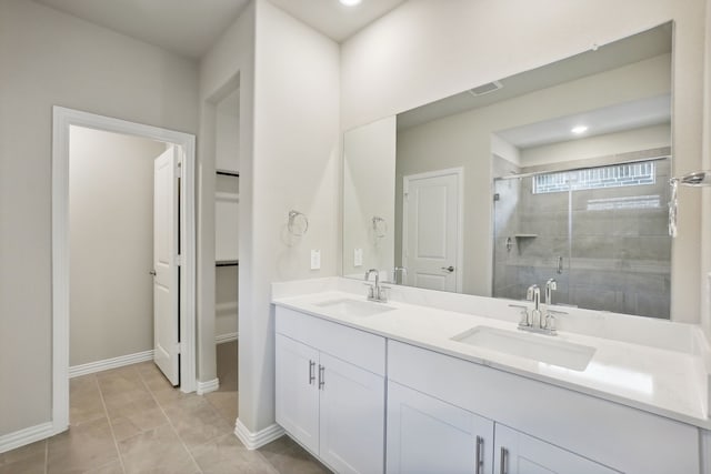 414 Stagg St, Mckinney, TX 75069 - bathroom featuring a shower stall, double vanity, baseboards, and tile patterned floors