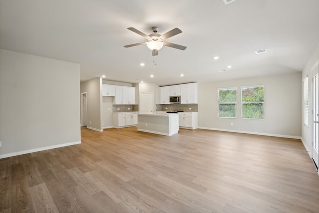 414 Stagg St, Mckinney, TX 75069 - unfurnished living room with healthy amount of natural light, ceiling fan, light wood finished floors, and recessed lighting