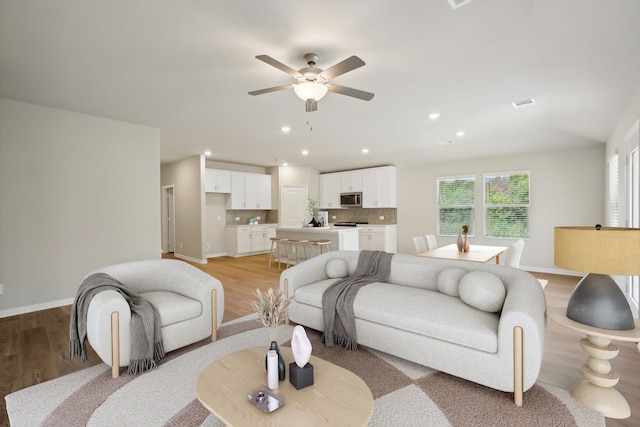 414 Stagg St, Mckinney, TX 75069 - living room with light wood-style floors, ceiling fan, recessed lighting, and baseboards
