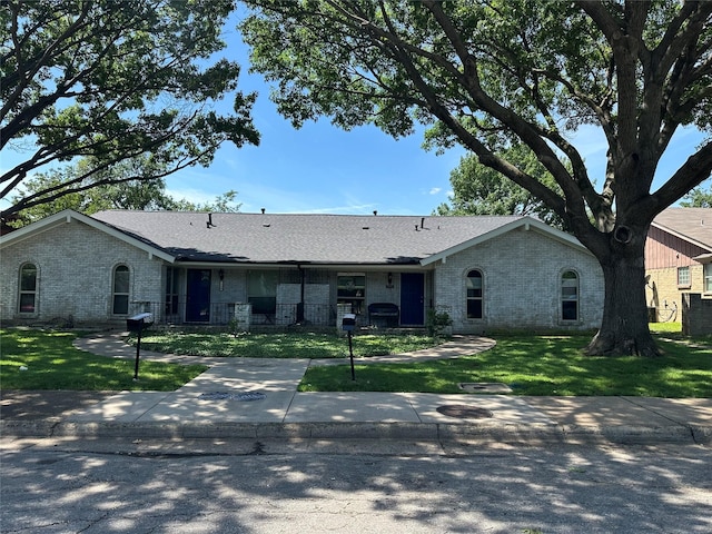 7750 Dentcrest Dr, Dallas, TX 75254 - ranch-style house featuring brick siding, a front lawn, and roof with shingles